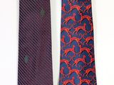 two ties with red and blue designs on them sitting next to each other