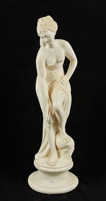 an image of a statue of a woman sitting on top of a table