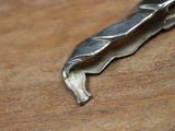 a piece of metal that has been cut in half