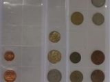 a lot of coins that are in a plastic container