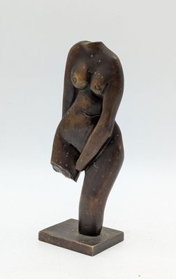 sculpture of a woman holding a baby on a wooden base
