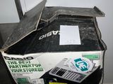 a box with a calculator and a laptop on top of it