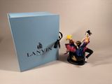 the figurine is next to a blue box with a figurine on it