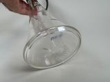 a person that is holding a glass cup with a handle