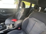 the interior of a car with grey leather seats and a center console