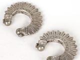 a pair of silver earrings with pearls on them