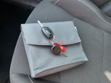 a car seat with a car key and a car key holder on it