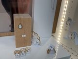 a display of jewelry on a glass shelf in a store
