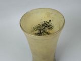 a vase with a tree in it sitting on a table