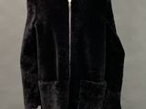 an image of a mannequin wearing a black coat and hat