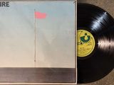 the vinyl album is laying on the ground with a red flag on it