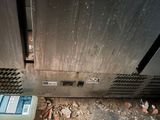 a dirty air conditioner sitting in the corner of a room