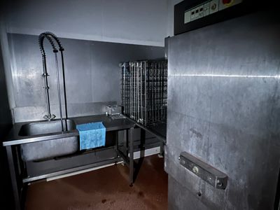 a kitchen with a sink and a refrigerator in it