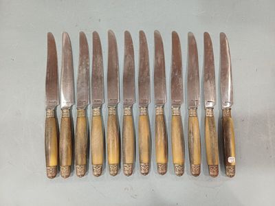 six knives are lined up next to each other on a table
