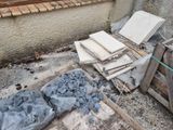 a pile of rubble sitting on the ground next to a building