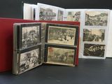 several old black and white photos are stacked in a red book