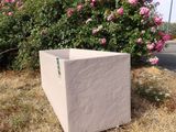 a box sitting in the middle of a field of grass