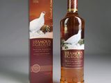 an image of a bottle of whisky sitting next to a box