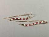 pair of ruby and diamond earrings on a white surface
