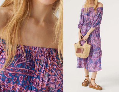 a woman wearing a purple dress and a straw bag