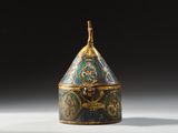 an ornately decorated box sitting on top of a white surface