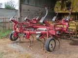 a picture of a tractor and a farm equipment in a barn
