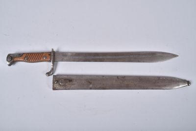 pair of two knives on a white surface with a knife in the middle
