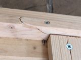 a close up of a piece of wood with screws on it
