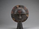 an image of a wooden sculpture of a face on a pedestal