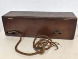 an old wooden box with a rope on top of it on a table