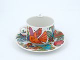 a cup and saucer with a bird design on it