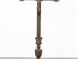 an image of a cross on a pedestal with a bird on it