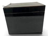 a black box that is sitting on a white surface