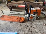 a chainsaw sitting on the ground next to a box