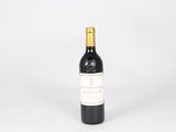 a bottle of wine sitting on top of a white table