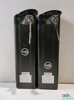 two black speakers sitting on top of a table next to each other