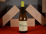 a bottle of wine sitting on a table next to a stack of wooden blocks