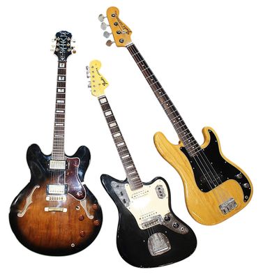 three guitars are lined up in a row on a white background