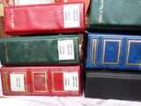 a lot of books that are stacked on top of each other