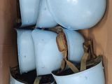 a cardboard box filled with blue bowls and cups