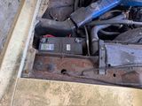 a car engine with a blue hose attached to it