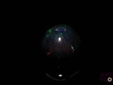 an image of a black oplite sphere in the dark