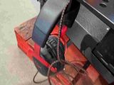 a close up of a remote control on a red tractor