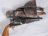 an old revolver with a leather holster on a white background