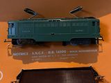 a green train car on display in a display case