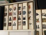 a lot of books that are stacked on a shelf