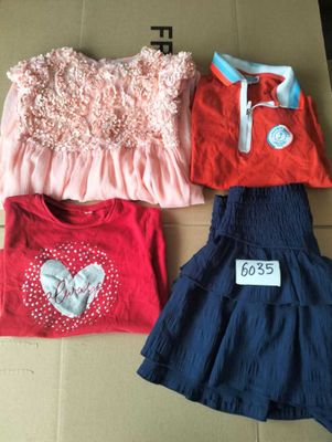 three children ' s clothes are on a cardboard box with a price tag