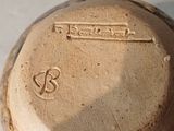a close up of a brown vase with writing on it