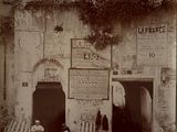 a black and white photo of a building with a bunch of signs on it