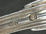 a close up of a silver spoon on a table